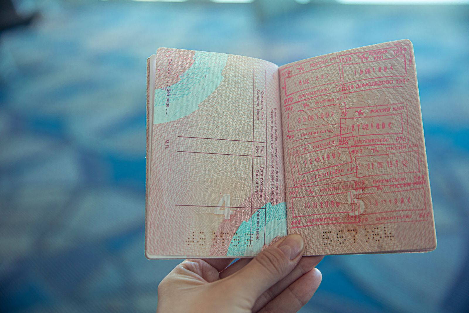 An open passport filled with entry and exit stamps from many countries